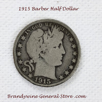 A 1915 Barber Half dollar coin in good plus condition with minor rim damage for sale by Brandywine General Store