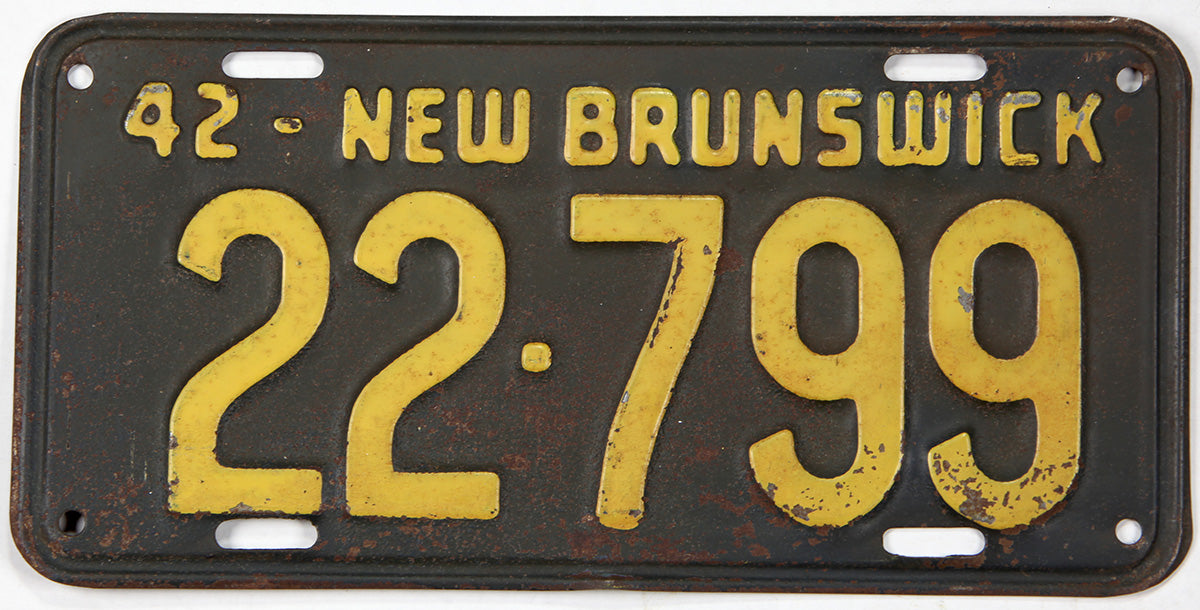 Vintage 1942 New Brunswick license plate with yellow text and numbers on a black background