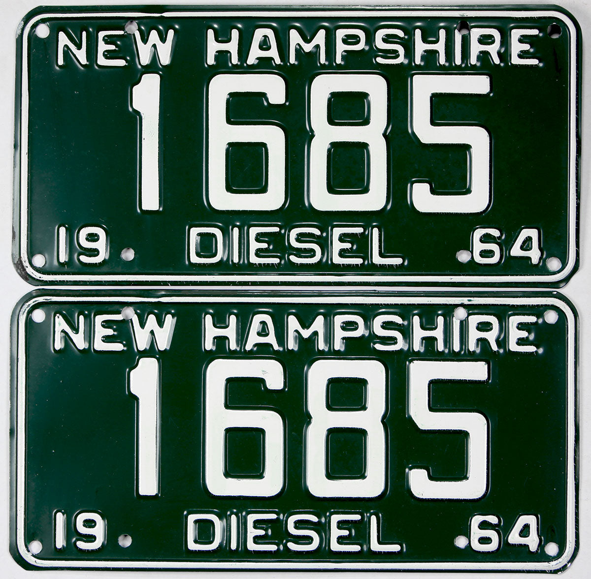Two New Hampshire diesel license plates from 1964 with the number 1685.