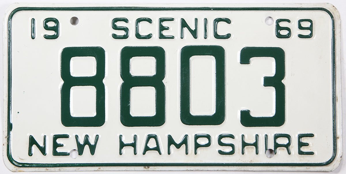 Vintage New Hampshire license plate from 1969 with the text 'Scenic 69' and number '8803'.