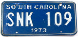 A 1973 South Carolina License Plate in very good condition wtih bends in the metal