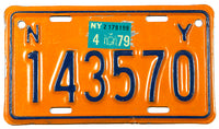 A 1979 New York motorcycle license plate in excellent condition wtih some scratching behind the sticker