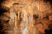 A fine art print of an explosive view of a small room in Luray Caverns where the ceiling and floor formations are joining in the middle