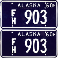 A pair of 1960 Alaska For Hire license plates which are new old stock and will grade near mint