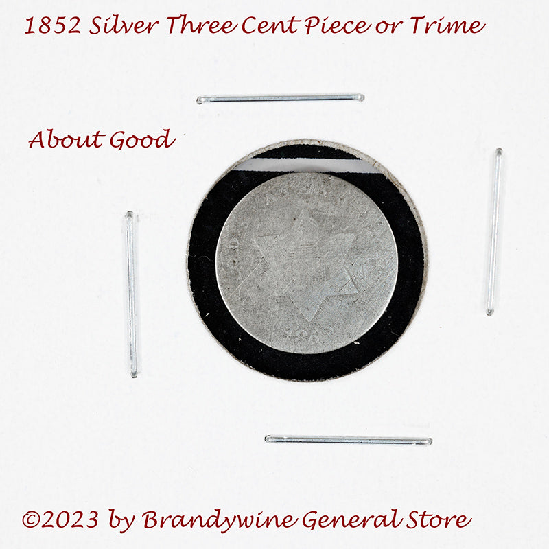 An 1852 Silver Three Cent Piece Trime in about good condition