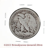 A 1935 Walking Liberty Half Dollar coin in average circulated condition reverse side of coin