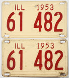 Pair of vintage 1953 Illinois license plates with red text on a beige background.