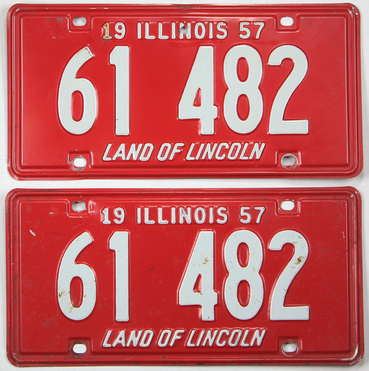 antique pair of 1957 Illinois car license plate being red with white lettering