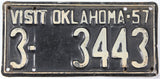 Vintage license plate with 'Visit Oklahoma 57' text and numbers '3-3443'.