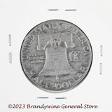 A 1958-D Franklin Half Dollar in average circulated condition reverse side of coin
