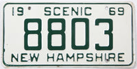 Vintage New Hampshire license plate from 1969 with the text 'Scenic 69' and number '8803'.