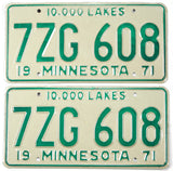 Two vintage license plates with '7ZG 608' and '19 Minnesota 71' text on a light green background.