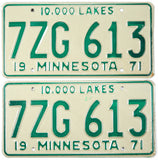 Pair of vintage 71 Minnesota auto license plates with green text on a beige background.
