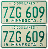 Pair of vintage 1971 Minnesota car license plates with green text on a white background.