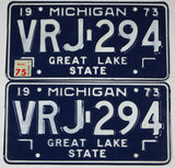 A pair of classic 1975 Michigan Car License Plates made of steel for sale by Brandywine General Store in excellent condition