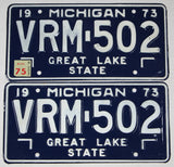 A pair of classic 1975 Michigan Car License Plates made of steel for sale by Brandywine General Store in excellent minus condition