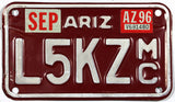 A 1996 Arizona Motorcycle License Plate which is in Excellent Minus Condition and has been lightly used with a bend