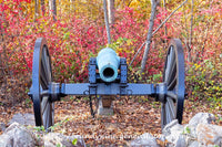 An original premium quality art print of Confederate Cannon Between Rocks and Fall Brush in Gettysburg Military Park for sale by Brandywine General Store
