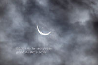 An original premium Quality Art Print of Solar Eclipse 2024 in a Cloudy Sky for sale by Brandywine General Store