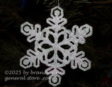 art print of a glittering white snowflake hanging on a Christmas tree