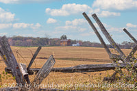 art print of the Henry House visible through a section of Civil War defensive picket fence at Manassas
