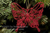 art print of glittering red butterfly hanging on a Christmas tree