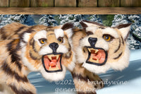 art print of two stuffed toy tigers escaping from under a building