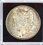 An 1886 Morgan Silver Dollar in extra fine or better condition with nice rainbow toning