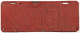 An antique 1924 Virginia car license plate in fair condition with extra holes and red primer paint