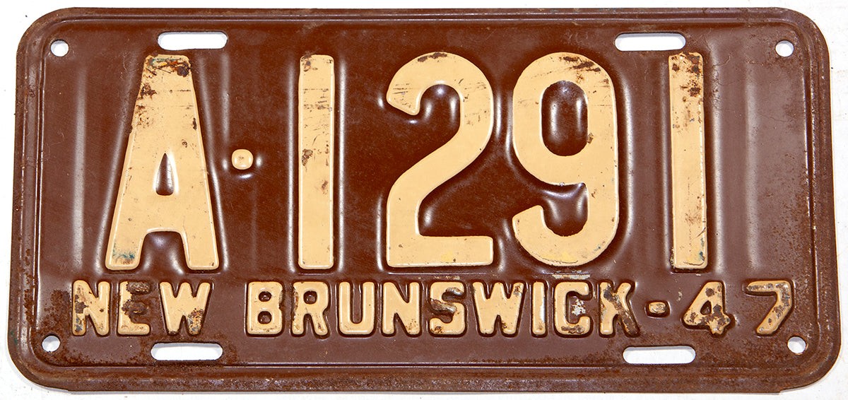 An antique 1947 New Brunswick commercial 1/4 year license plate in very good condition