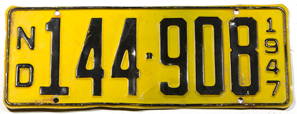 An antique 1947 North Dakota passenger car license plate in very good plus condition with some bends