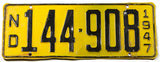 An antique 1947 North Dakota passenger car license plate in very good plus condition with some bends