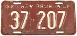 An antique 1952 New Brunswick passenger car license plate in very good minus condition