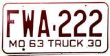 An antique NOS 1963 Missouri farm license plate in excellent or better condition with wrapper