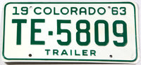 A vintage New Old Stock 1963 Colorado trailer license plate in excellent minus condition with the original wrapper