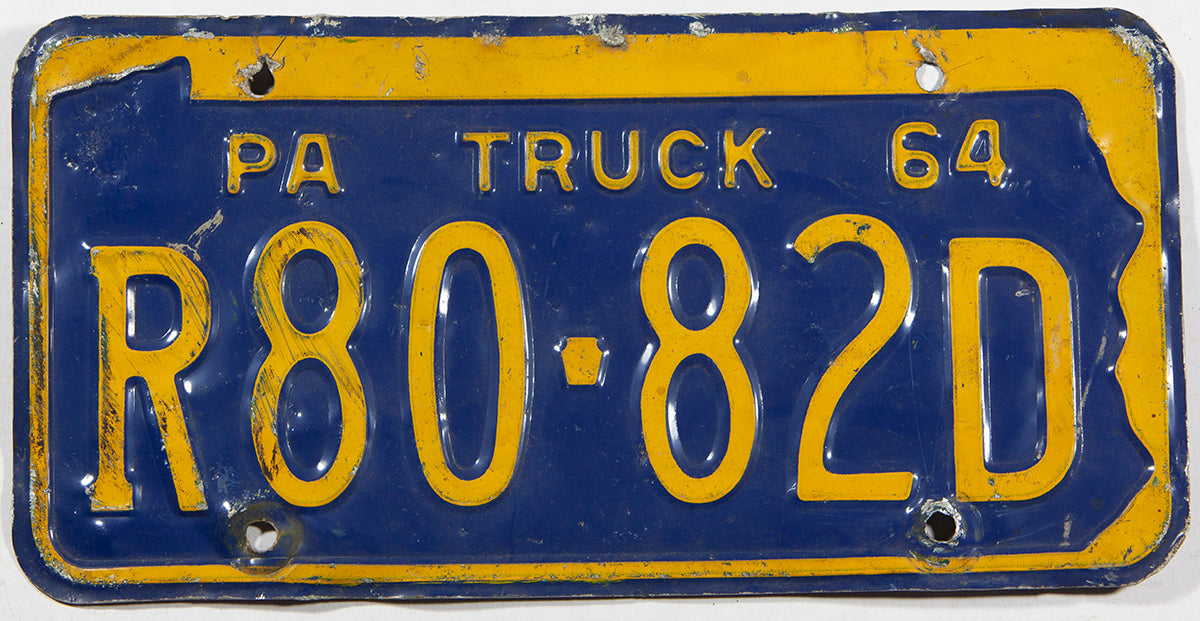 A 1964 Pennsylvania truck license plate in  good plus condition with many bends