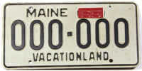A classic 1965 Maine sample license plate in excellent minus condition along with the red 65 metal year tab