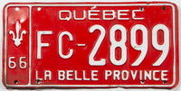 A 1966 Quebec truck license plate in very good condition with some bends