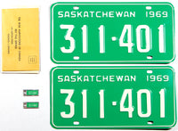 A near mint pair of 1969 Saskatchewan Canada license plates still with their matching War Amputations key tags