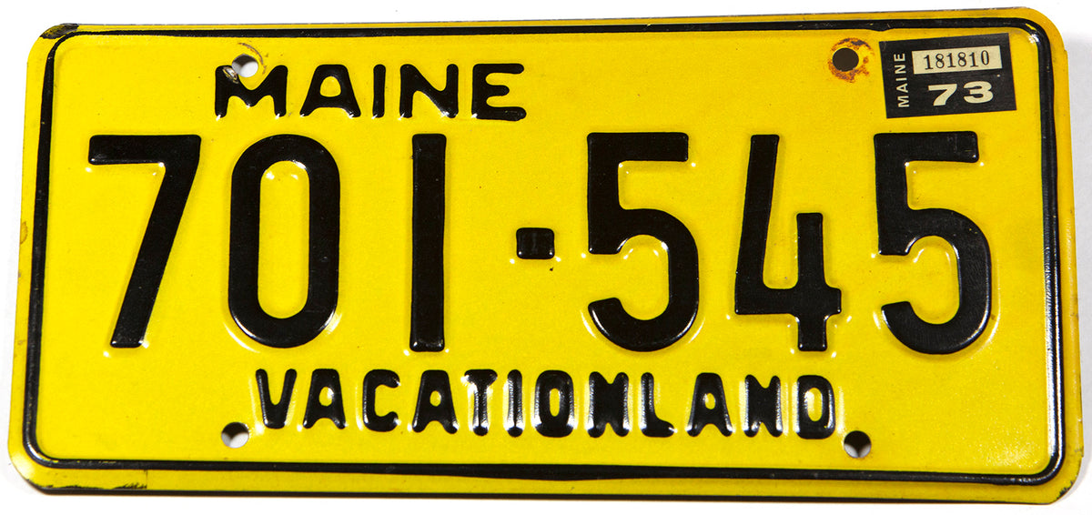 A classic 1973 Maine DMV car license plate in excellent minus condition