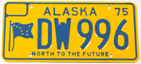 A classic 1975 Alaska passenger car license plate in new old stock near mint condition with the original wrapper