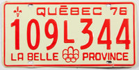 A classic 1976 Quebec passenger car license plate in excellent minus condition wtih a bend at bolt slot
