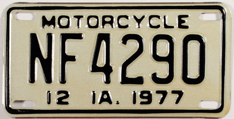 A NOS 1977 Iowa Motorcycle License Plate which is in unused excellent plus condition