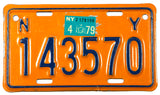 A 1979 New York motorcycle license plate in excellent condition wtih some scratching behind the sticker