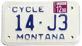 A 1998 Montana motorcycle license plate in excellent condition