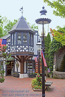 An archival premium Quality art Print of A Rooster Weather Vane on a Shop in Downtown Gatlinburg for sale by Brandywine General Store