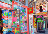 A Museum Quality Print of The Black Cat a Colorful Shop in Gatlinburg TN showing this unusual store on Main Street with it's many colors and posters