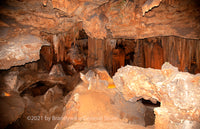 Chasm in Luray Cavernes looking into a room filled with all kinds of beautiful cave formations