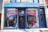 A premium quality art print of Cooperstown Baseball Bat Company Storefront with patriotic painted ball bats