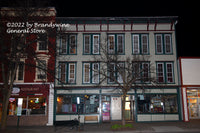A premium quality art print of Cooperstown Baseball Cards and Club House at night